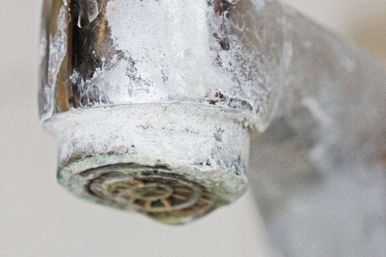 A faucet covered in soap scum.