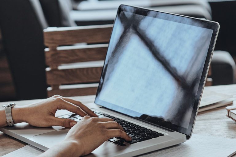 A woman working on a laptop.