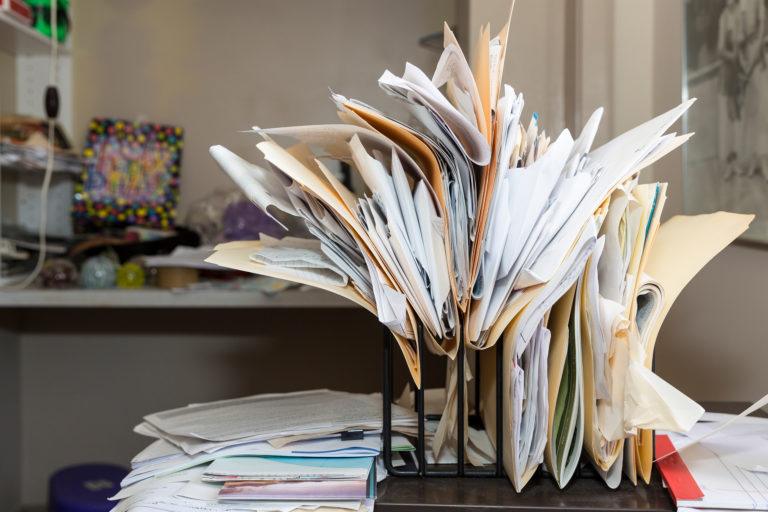 A desk overflowing with files.