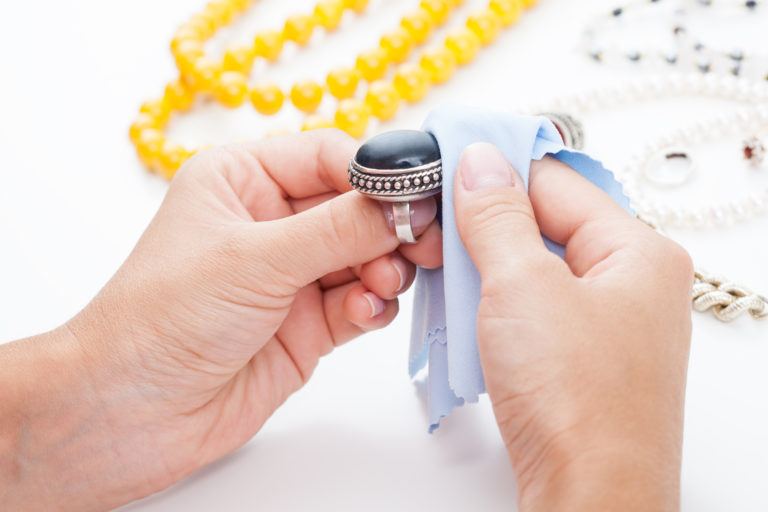 A person polishing a ring.