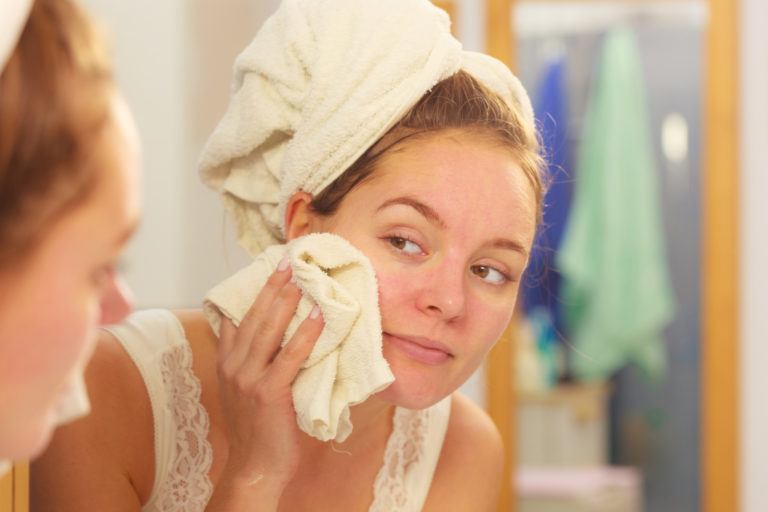 A woman washing her face.