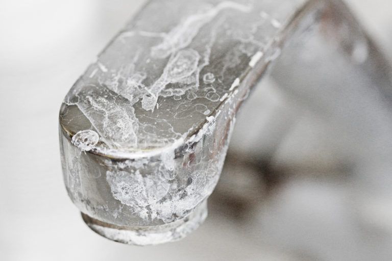 A soap scum stained chrome faucet.