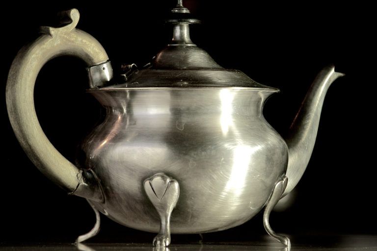 A pewter tea kettle.