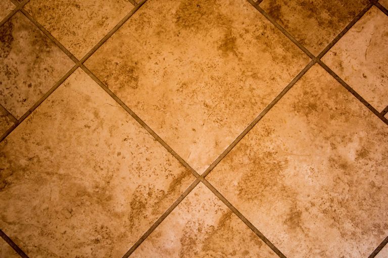 A floor tiled in travertine.