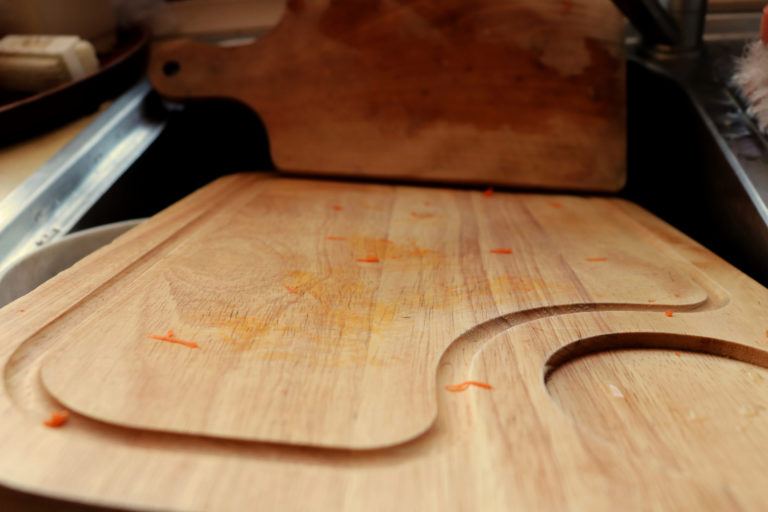 Dirty cutting boards in a sink.