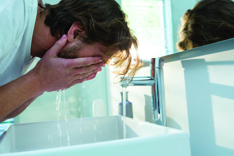 A man washing his face.
