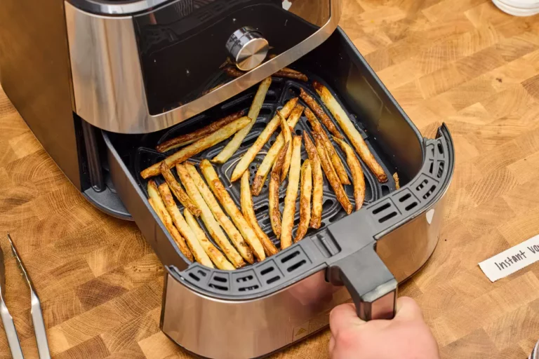 French fries being cooked in an air fryer.