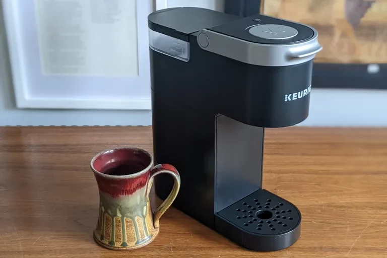 Picture of a clean keurig machine with a mug in the foreground